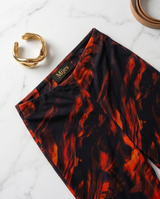 Pantalon flare à motifs marbrés orange et noir