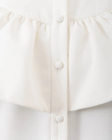 White ruffled shirt dress.